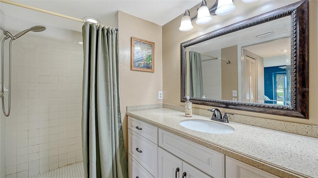 6611 Stone River Road, Unit 103 Bradenton, FL 34203 - Photo 24 of 61 a bathroom with a granite countertop sink and a mirror