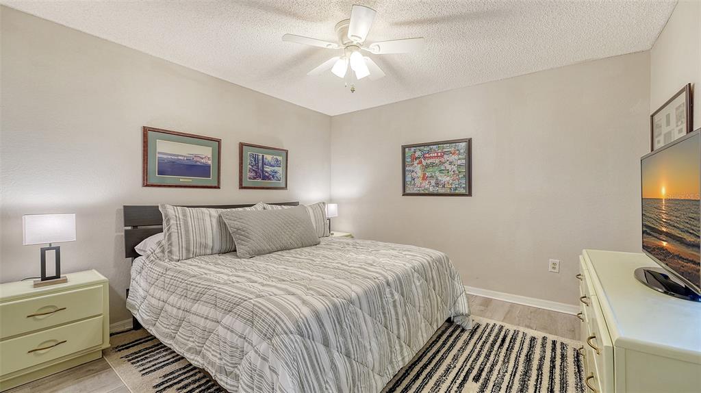 6611 Stone River Road, Unit 103 Bradenton, FL 34203 - Photo 25 of 61 a bedroom with a bed and a flat screen tv