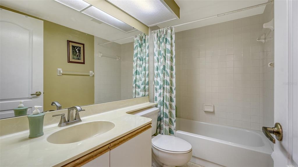 6611 Stone River Road, Unit 103 Bradenton, FL 34203 - Photo 26 of 61 a bathroom with a granite countertop sink toilet and shower