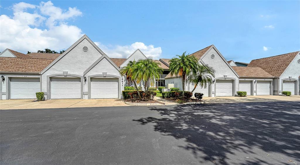 6611 Stone River Road, Unit 103 Bradenton, FL 34203 - Photo 27 of 61 a view of a house next to a road and yard