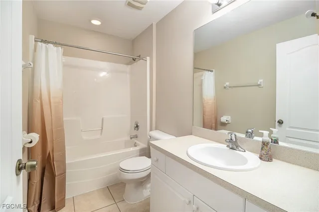 a bathroom with a sink a toilet and a large mirror