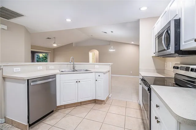 a kitchen with a sink cabinets and appliances