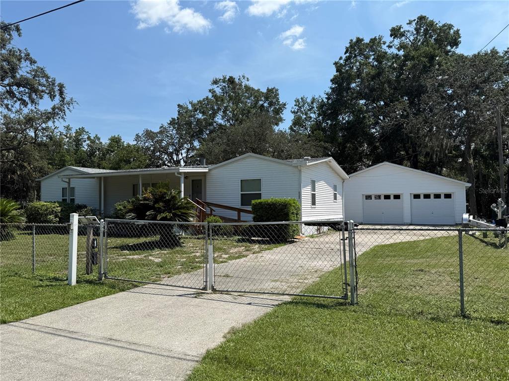 a front view of house with a yard and a garden