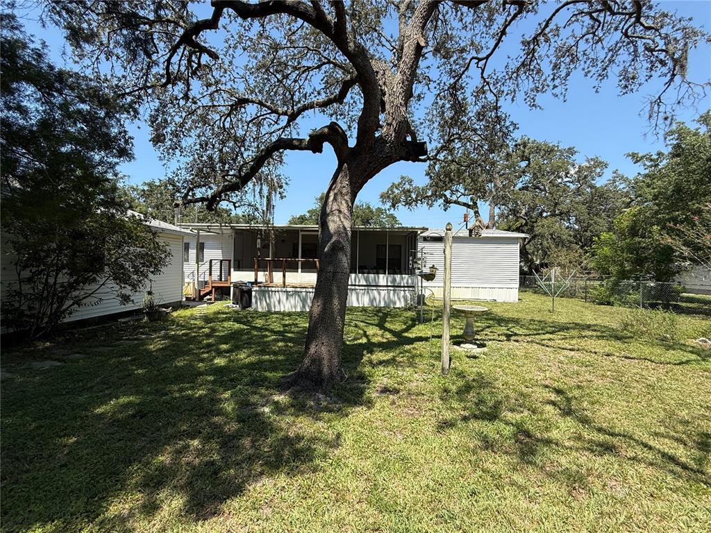9300 Ottawa Street New Port Richey, FL 34654 - Photo 11 of 37 a backyard of a house with lots of green space