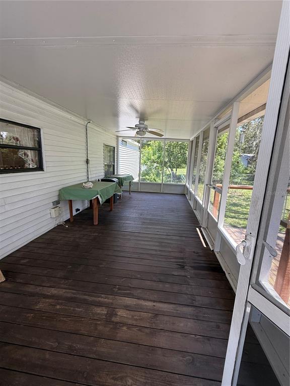 9300 Ottawa Street New Port Richey, FL 34654 - Photo 12 of 37 a living room with furniture floor to ceiling window and wooden floor