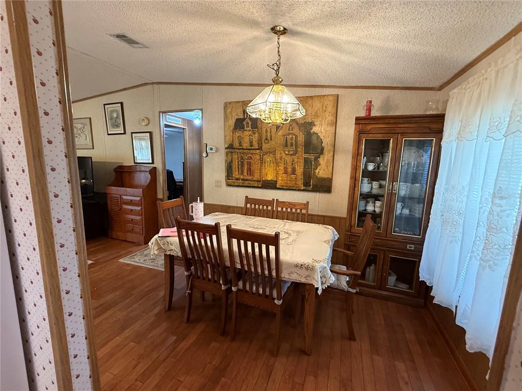 9300 Ottawa Street New Port Richey, FL 34654 - Photo 19 of 37 a view of a dining room with furniture window and wooden floor