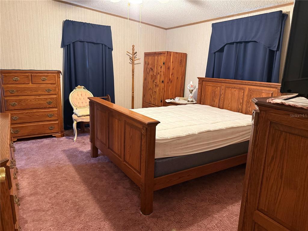 9300 Ottawa Street New Port Richey, FL 34654 - Photo 25 of 37 a bedroom with a bed and a dresser