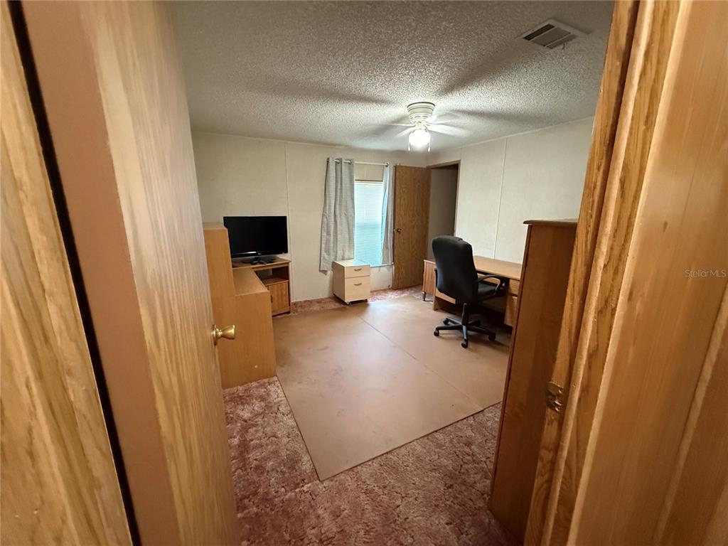 9300 Ottawa Street New Port Richey, FL 34654 - Photo 32 of 37 a view of a hallway with workspace and mirror