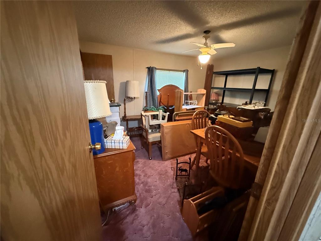 9300 Ottawa Street New Port Richey, FL 34654 - Photo 34 of 37 a view of a workspace with furniture and a window