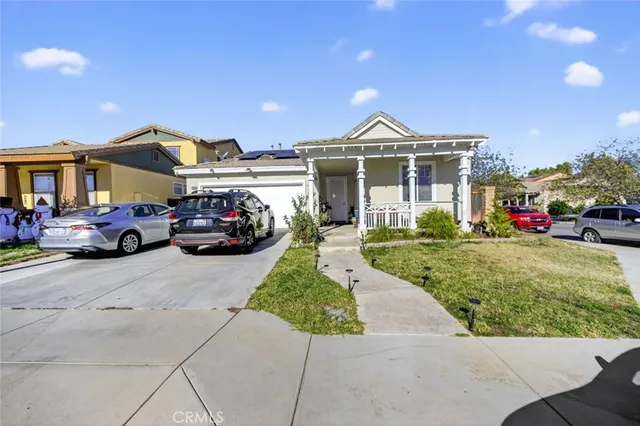a front view of a house with a garden and fire pit