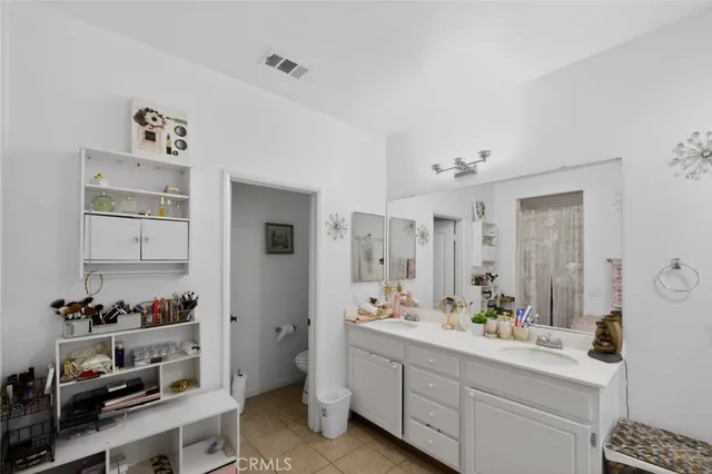 a spacious bathroom with a double vanity sink and a mirror