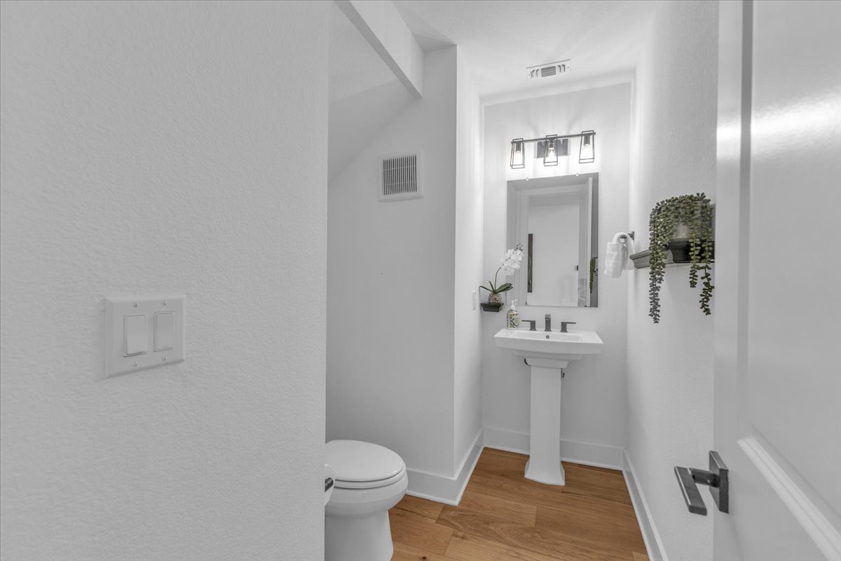 2312 Mondello Path Leander, TX 78641 - Photo 20 of 40 Bathroom featuring toilet and light wood-style floors
