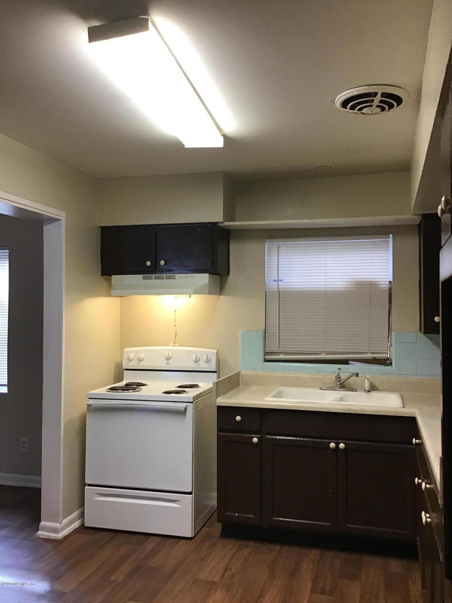 7542 Strato Road Jacksonville, FL 32210 - Photo 8 of 21 a kitchen with stainless steel appliances a stove and a microwave