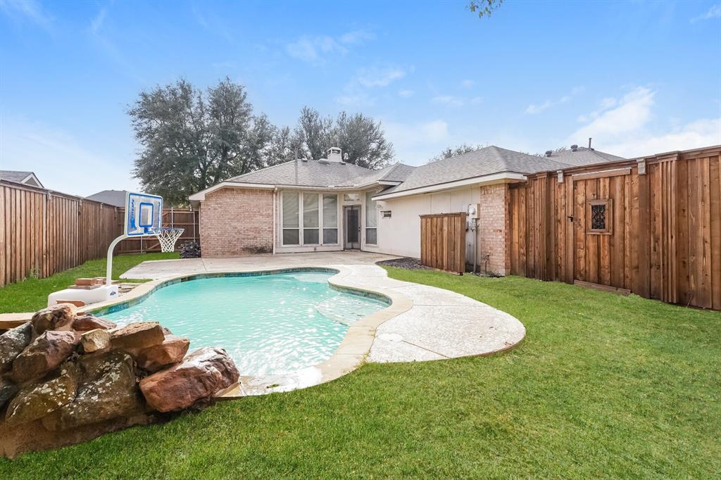 10706 Robincreek Lane Frisco, TX 75035 - Photo 15 of 17 Rear view of house featuring a fenced backyard, brick siding, a patio area, and roof with shingles