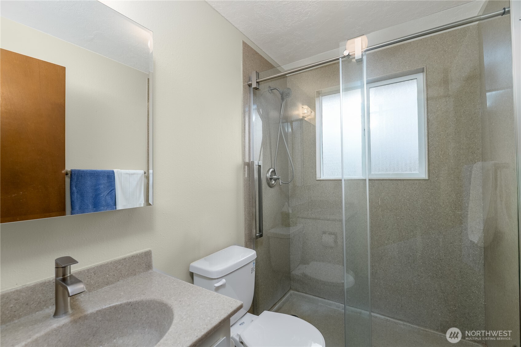 1111 West Alder Court Sequim, WA 98382 - Photo 23 of 37 a bathroom with a shower a toilet and sink