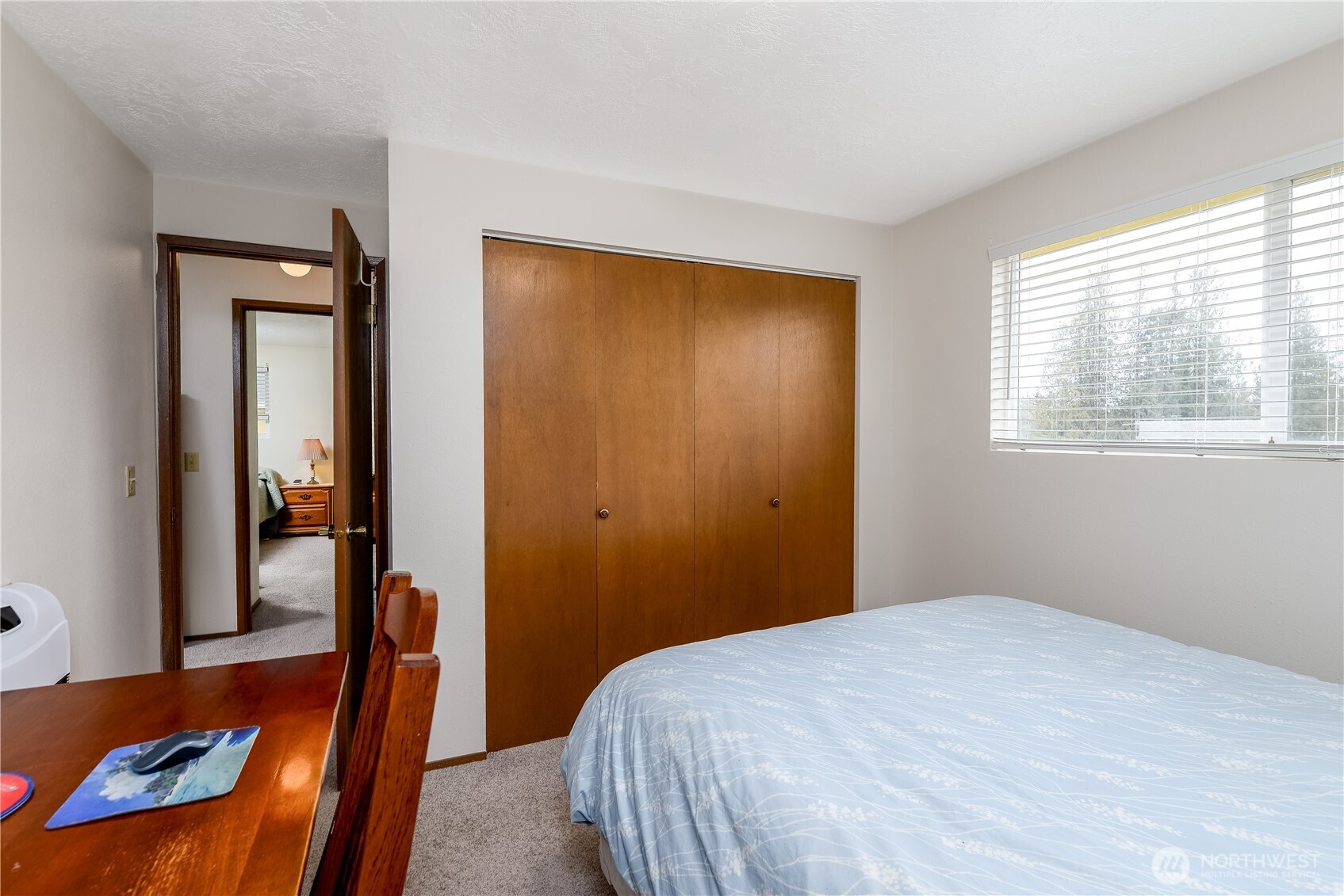 1111 West Alder Court Sequim, WA 98382 - Photo 25 of 37 a bedroom with a bed and wooden floor