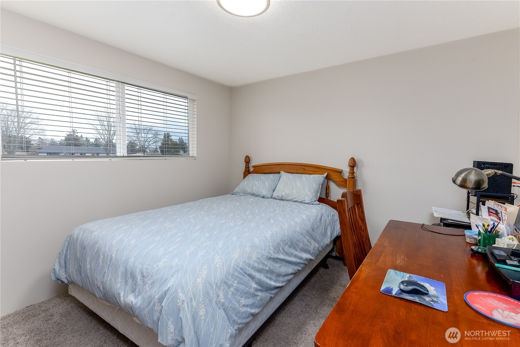 1111 West Alder Court Sequim, WA 98382 - Photo 26 of 37 a bed sitting in a bedroom next to a window