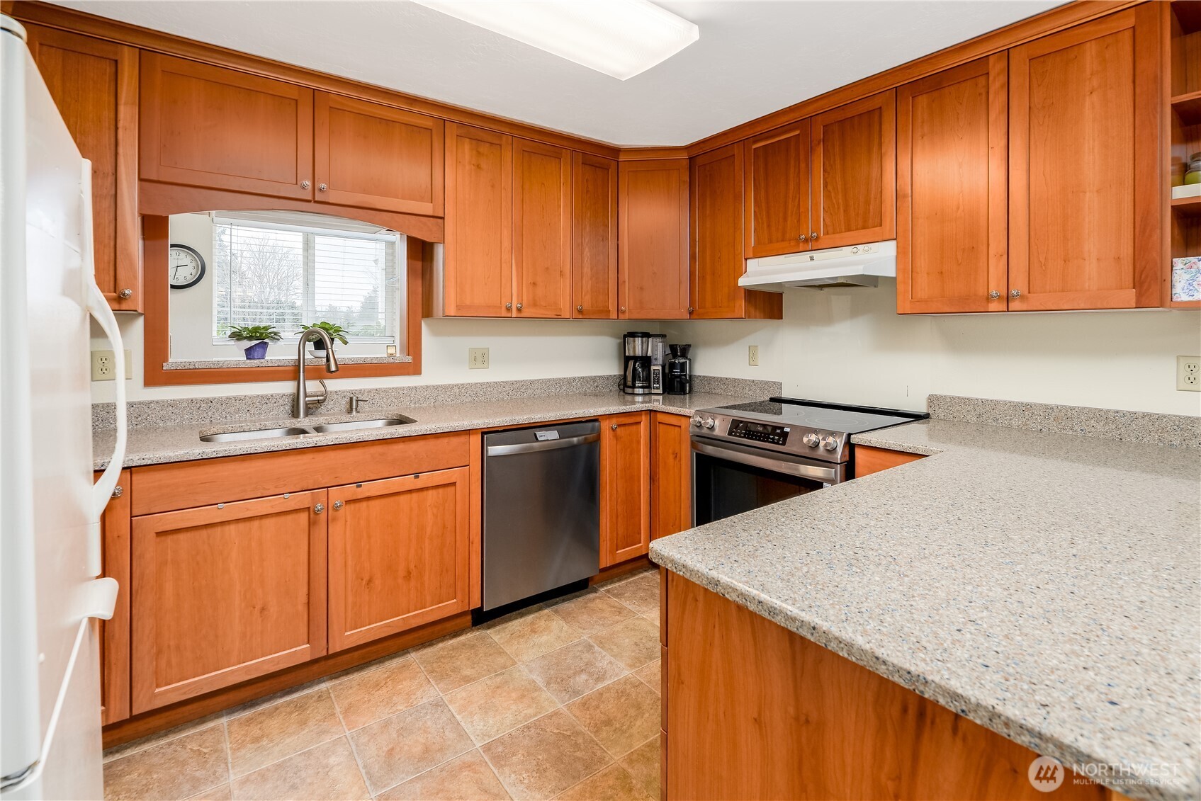 1111 West Alder Court Sequim, WA 98382 - Photo 4 of 37 a kitchen with stainless steel appliances granite countertop wooden cabinets a sink and dishwasher