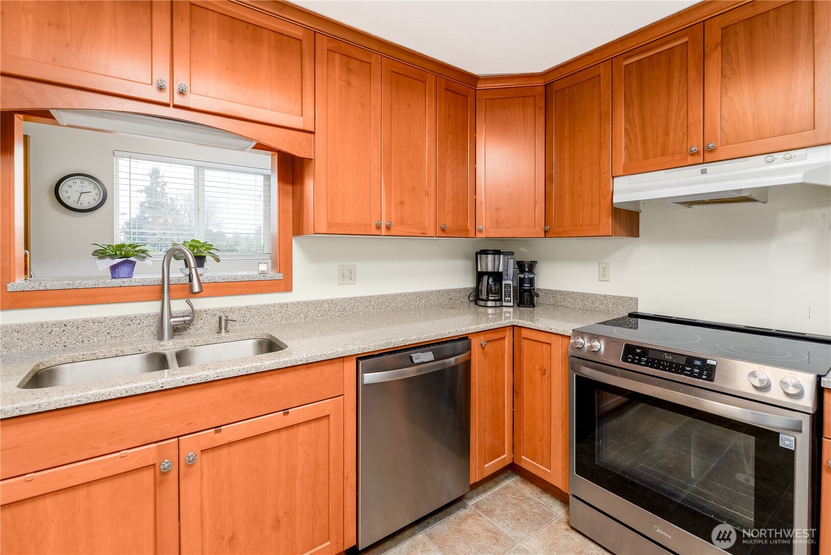 1111 West Alder Court Sequim, WA 98382 - Photo 5 of 37 a kitchen with stainless steel appliances granite countertop a sink a stove and cabinets