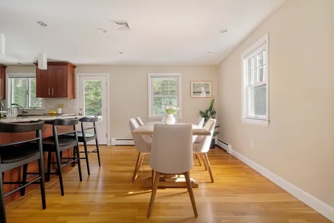 a view of a dining room with furniture and wooden floor