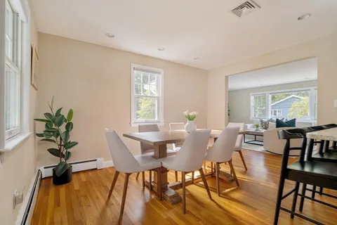 a view of a dining room with furniture and a potted plant