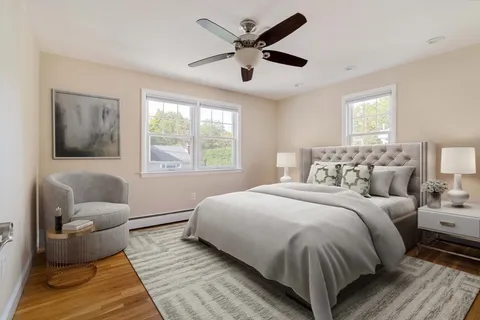 a bedroom with bed couch and window