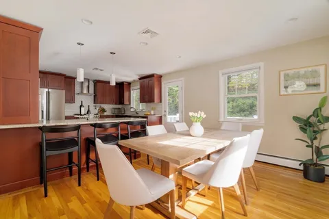 a view of a dining room with furniture and wooden floor