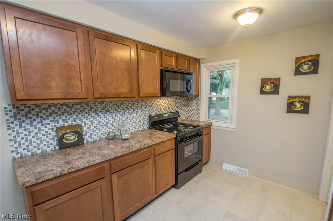 10571 Snow Road Parma Heights, OH 44130 - Photo 6 of 25 Updated Kitchen with warm wood cabinetry