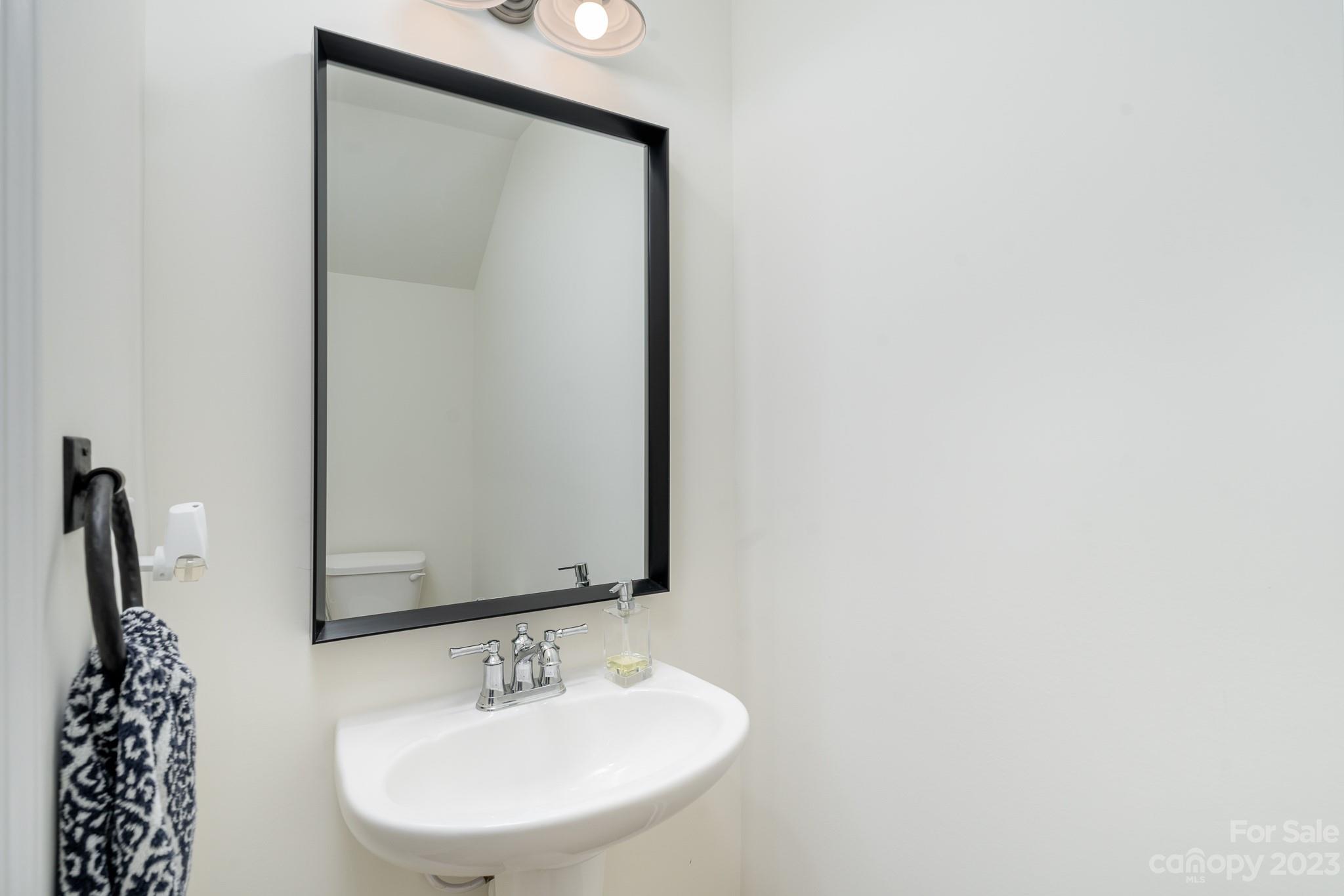 229 Quinn Road Matthews, NC 28104 - Photo 11 of 23 a bathroom with a sink and a mirror