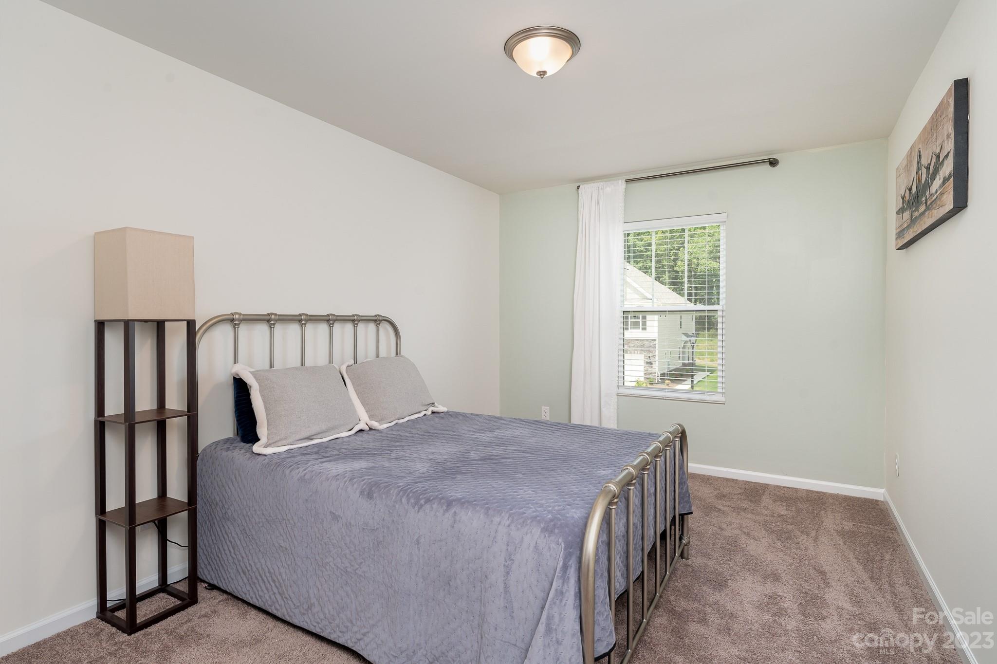 229 Quinn Road Matthews, NC 28104 - Photo 15 of 23 a bedroom with a bed and a window