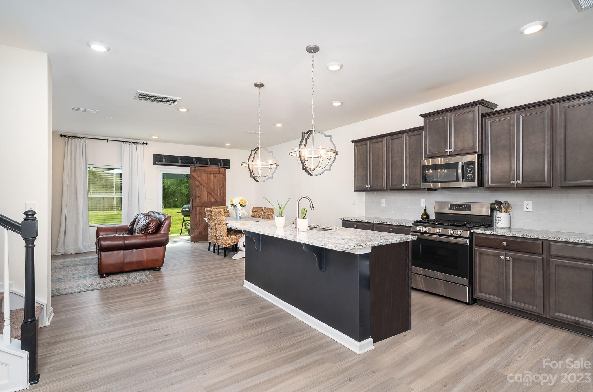 229 Quinn Road Matthews, NC 28104 - Photo 5 of 23 a large kitchen with cabinets