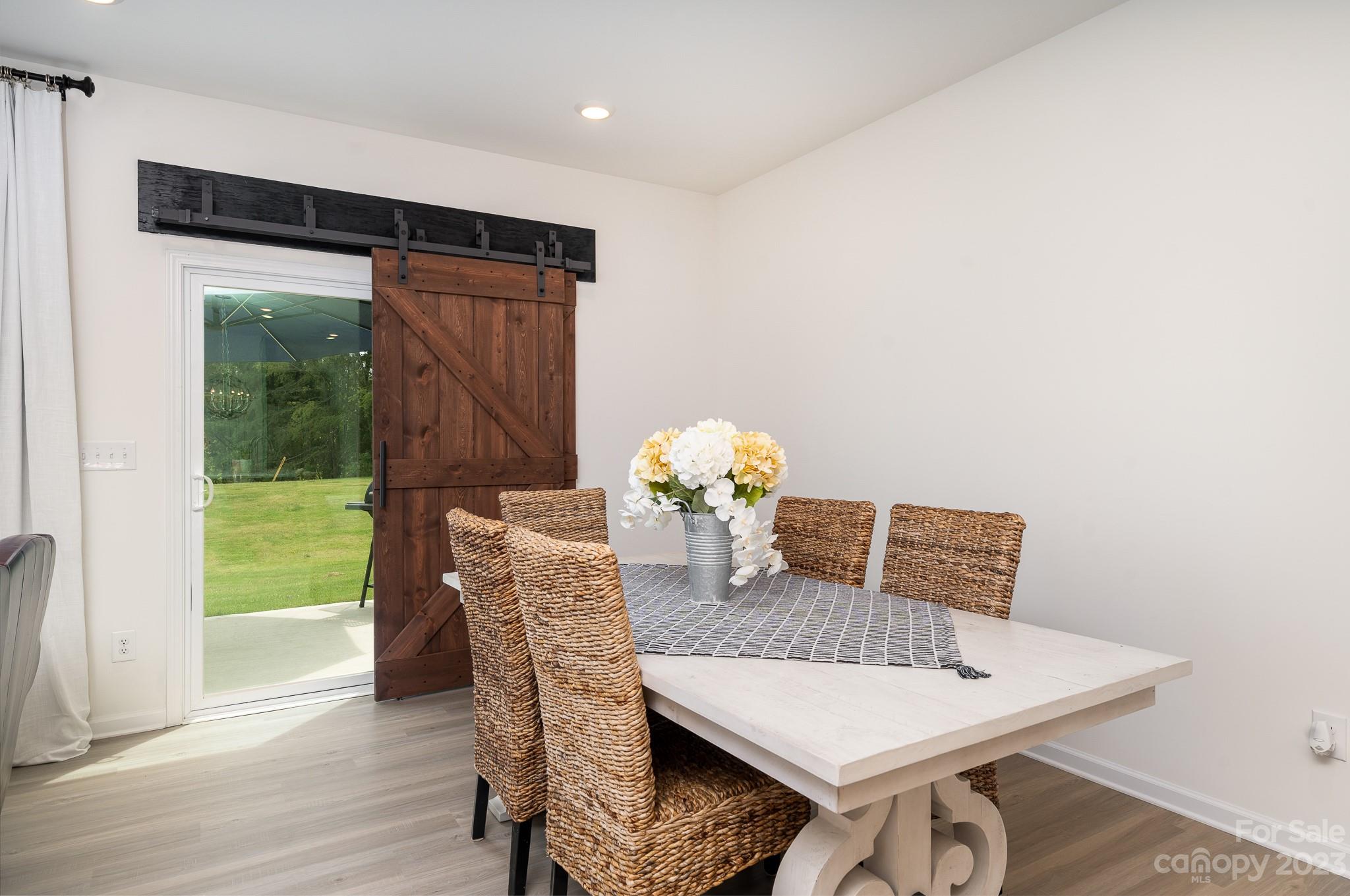 229 Quinn Road Matthews, NC 28104 - Photo 7 of 23 a view of a dining room with furniture window and wooden floor
