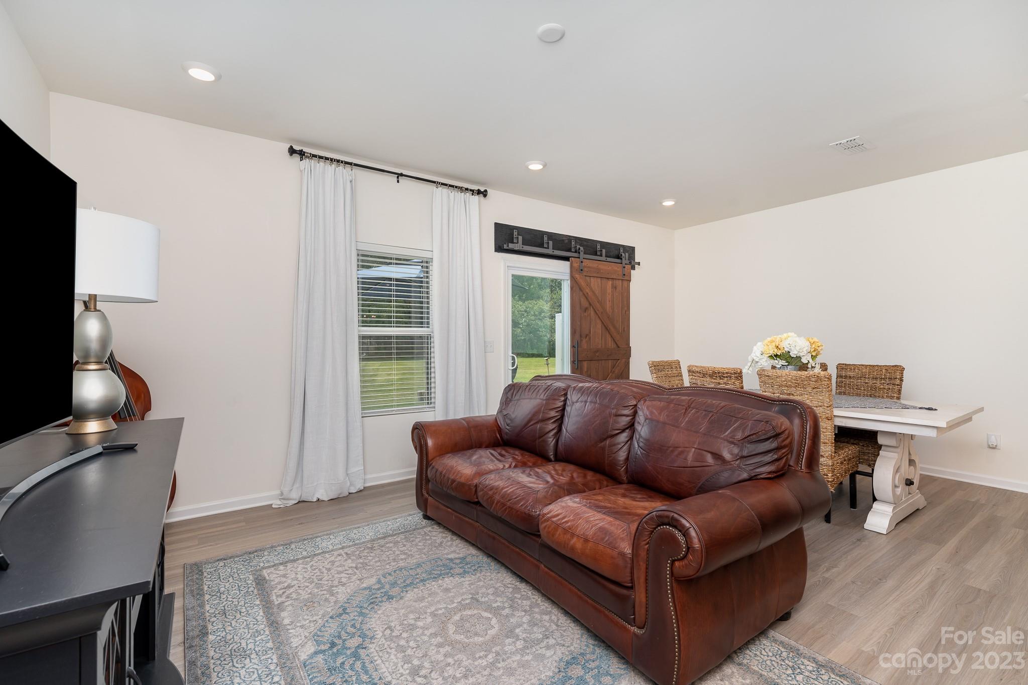 229 Quinn Road Matthews, NC 28104 - Photo 9 of 23 a living room with furniture a flat screen tv and a window