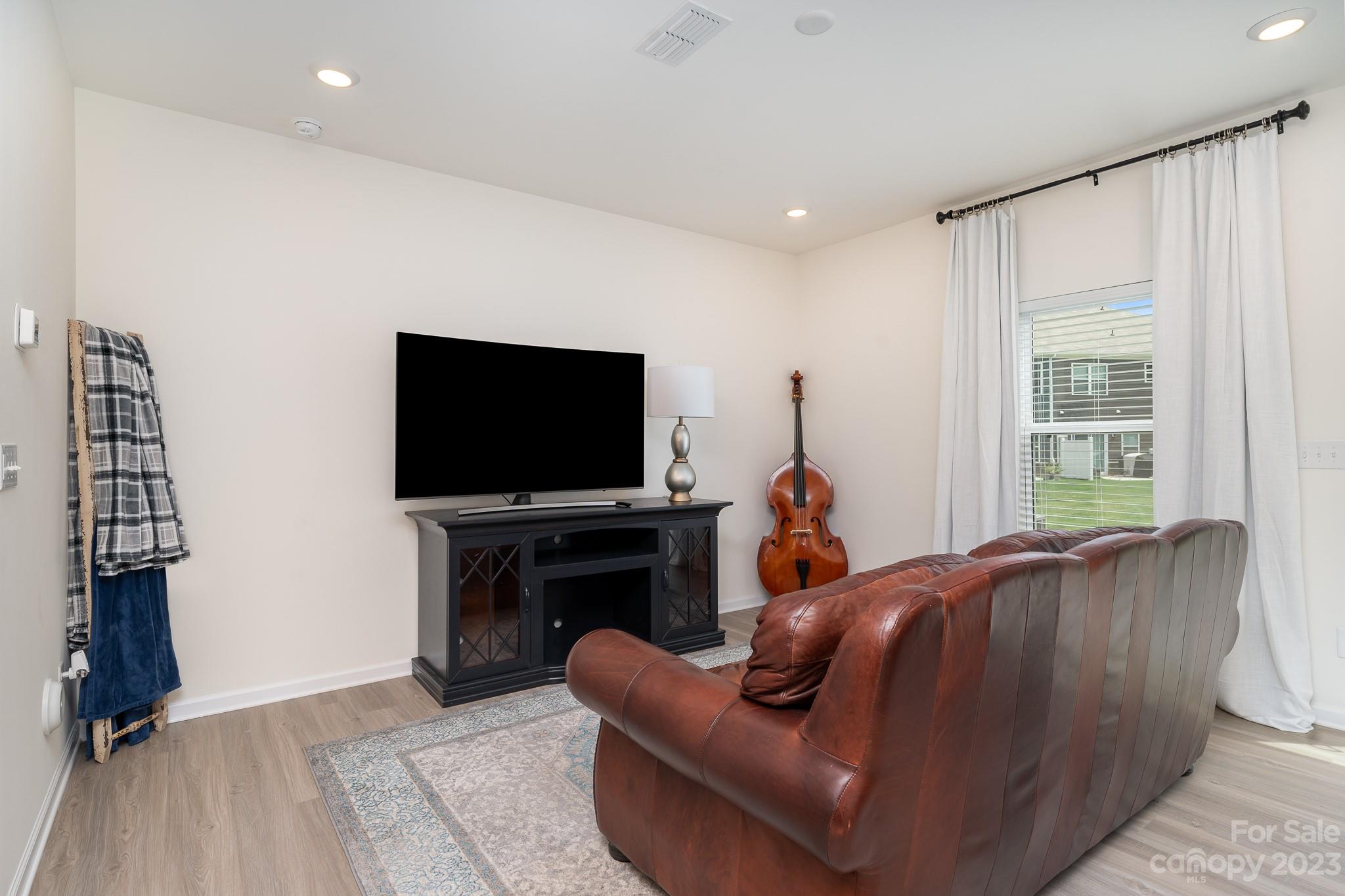 229 Quinn Road Matthews, NC 28104 - Photo 10 of 23 a living room with furniture and a flat screen tv