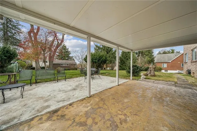 a view of a house with backyard and porch