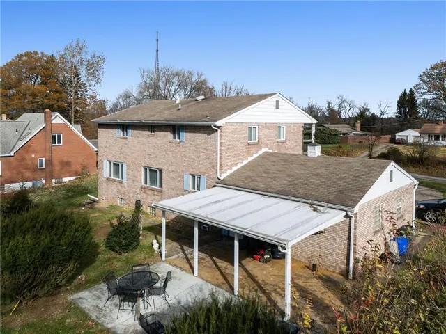 a view of a house with roof and sitting area