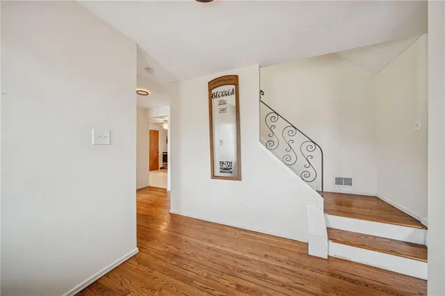 a view of an entryway with wooden floor