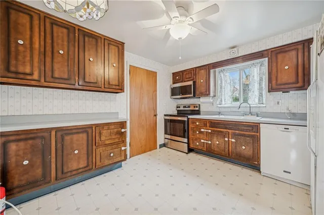 a kitchen with stainless steel appliances granite countertop a refrigerator sink and cabinets