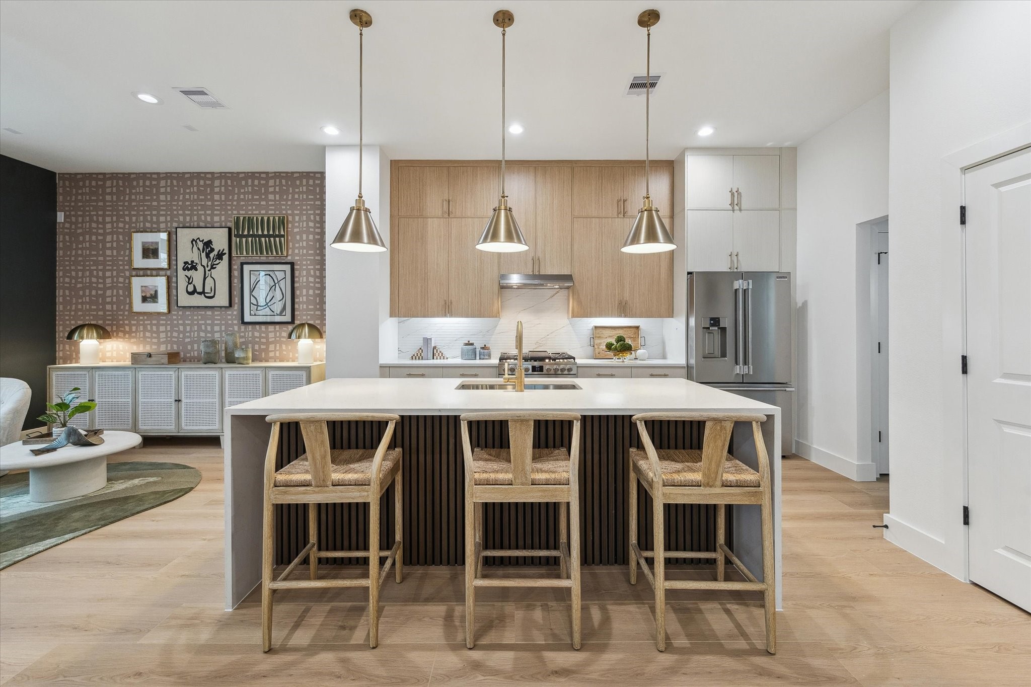 752 Curtin Street Houston, TX 77018 - Photo 13 of 37 Sleek and modern kitchen featuring a spacious island with seating for four, stylish pendant lighting, and stainless steel appliances.