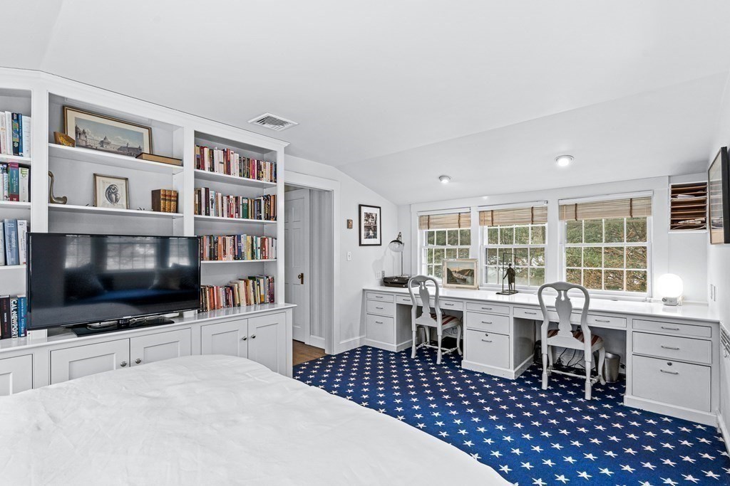 35 Sawyer Road Wellesley, MA 02481 - Photo 17 of 27 a living room with a flat screen tv and a bookshelf