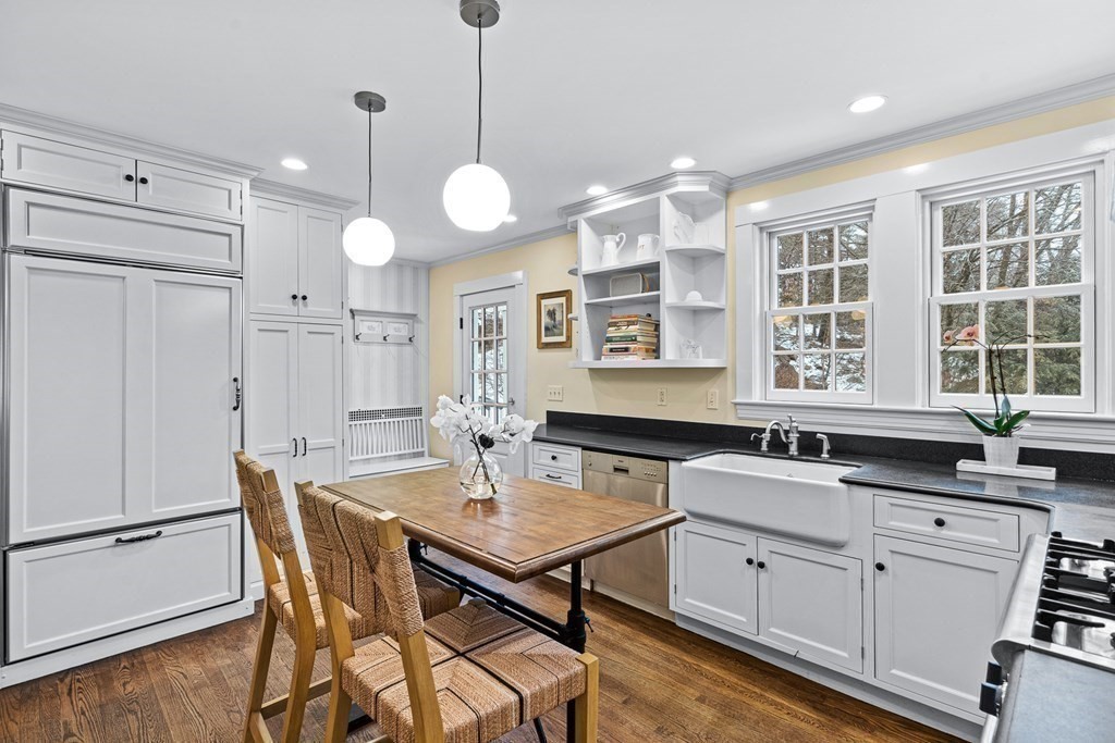 35 Sawyer Road Wellesley, MA 02481 - Photo 7 of 27 a kitchen with a table chairs stove and cabinets