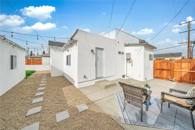 a spacious bathroom with a granite countertop sink a mirror and a shower