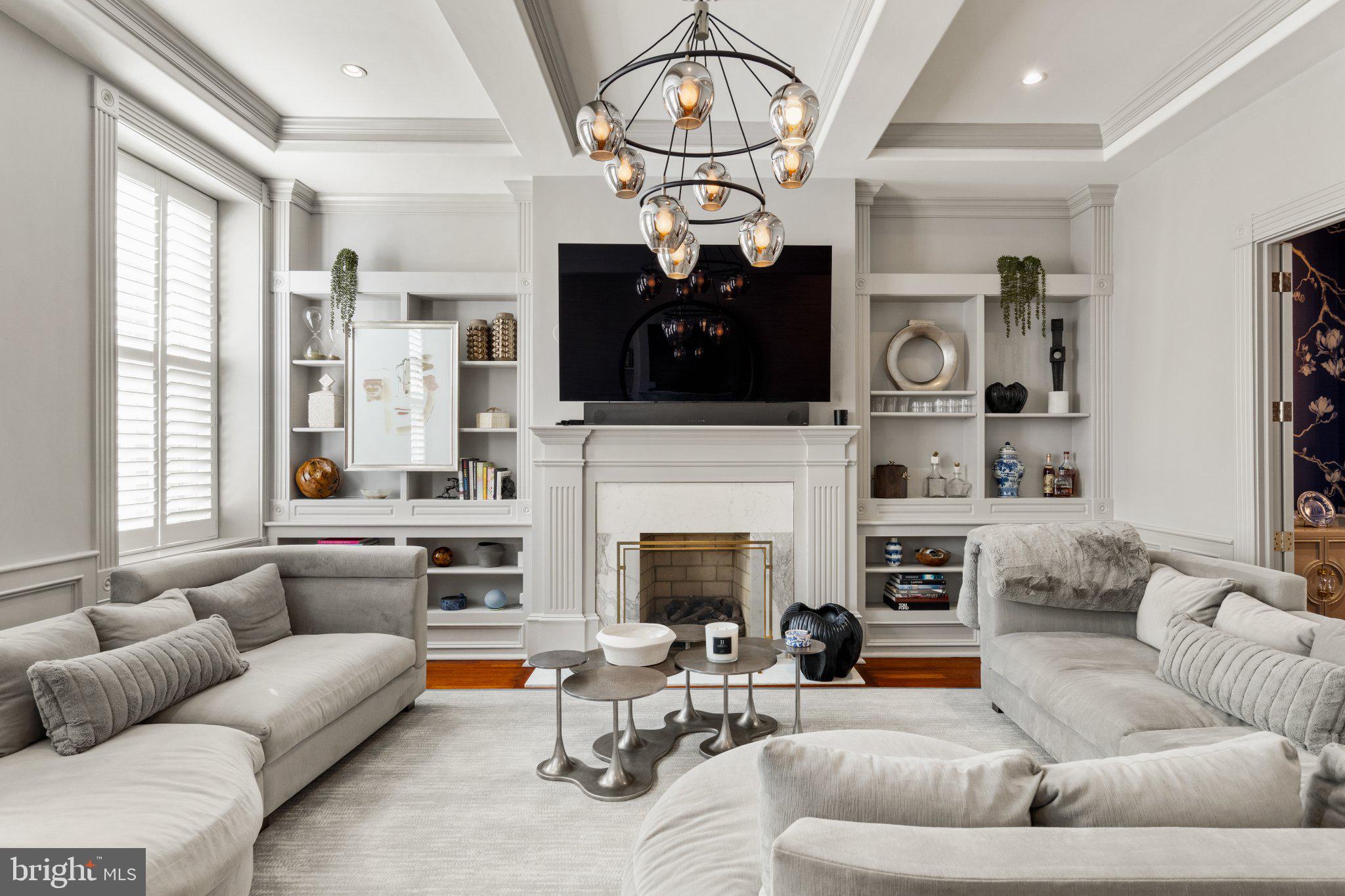 a living room with furniture a fireplace and a flat screen tv
