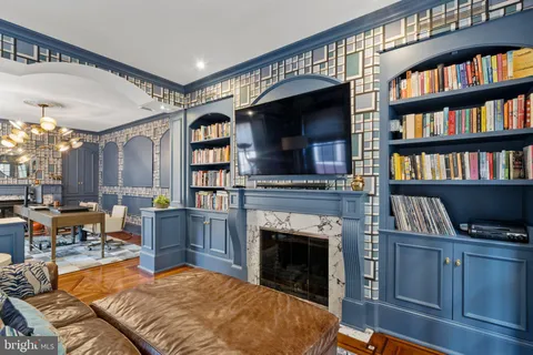 a bedroom with a bed and a lamp on dresser