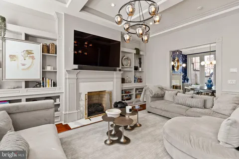 a living room with furniture a fireplace and flat screen tv