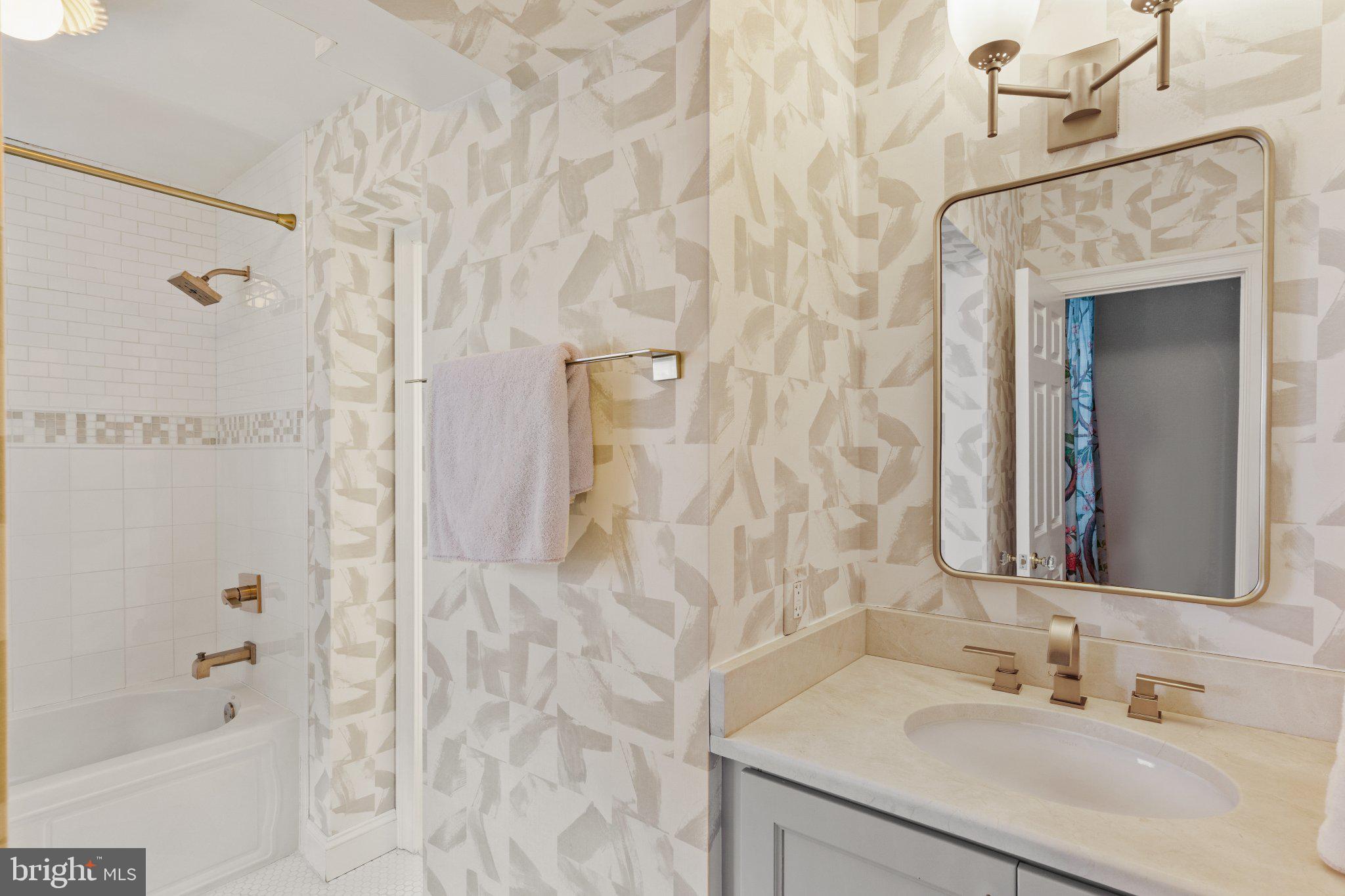 1013 Clinton Street Philadelphia, PA 19107 - Photo 42 of 53 a bathroom with a granite countertop shower sink and mirror