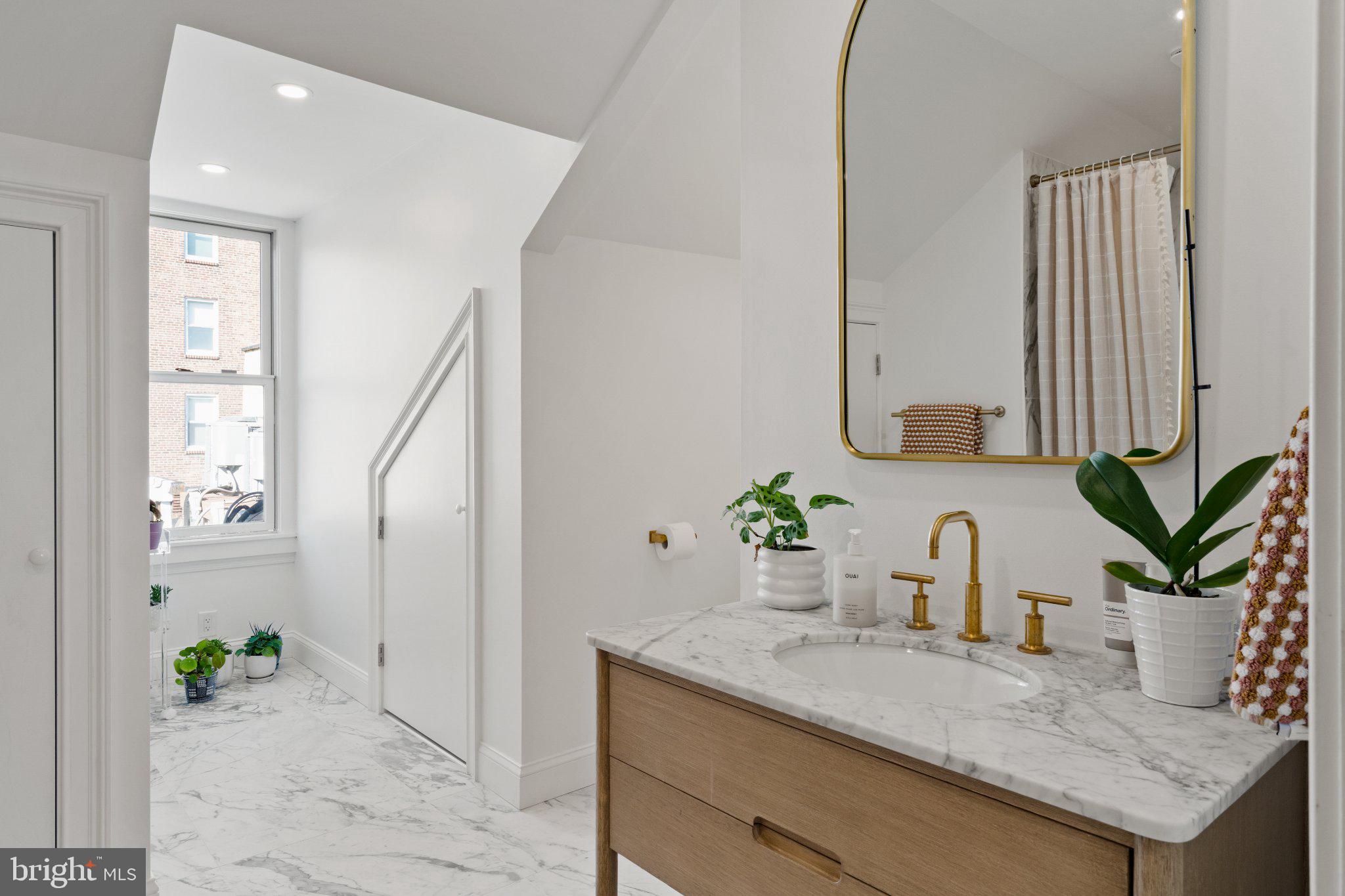 1013 Clinton Street Philadelphia, PA 19107 - Photo 47 of 53 a bathroom with a granite countertop sink and a mirror