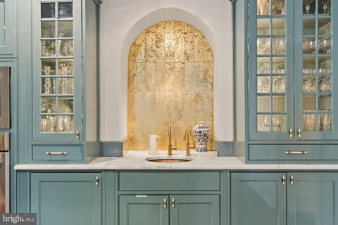 a kitchen with a sink and natural light
