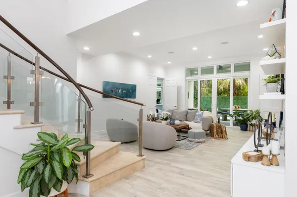 a living room with furniture potted plant and windows