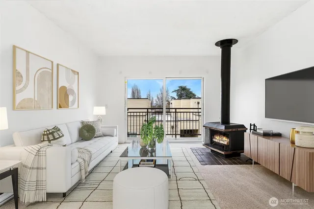 a living room with furniture a flat screen tv and a floor to ceiling window